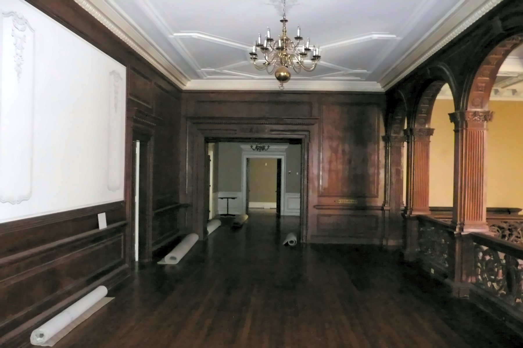 The Second Floor Center Hall before, empty, with rolled paper on the floor