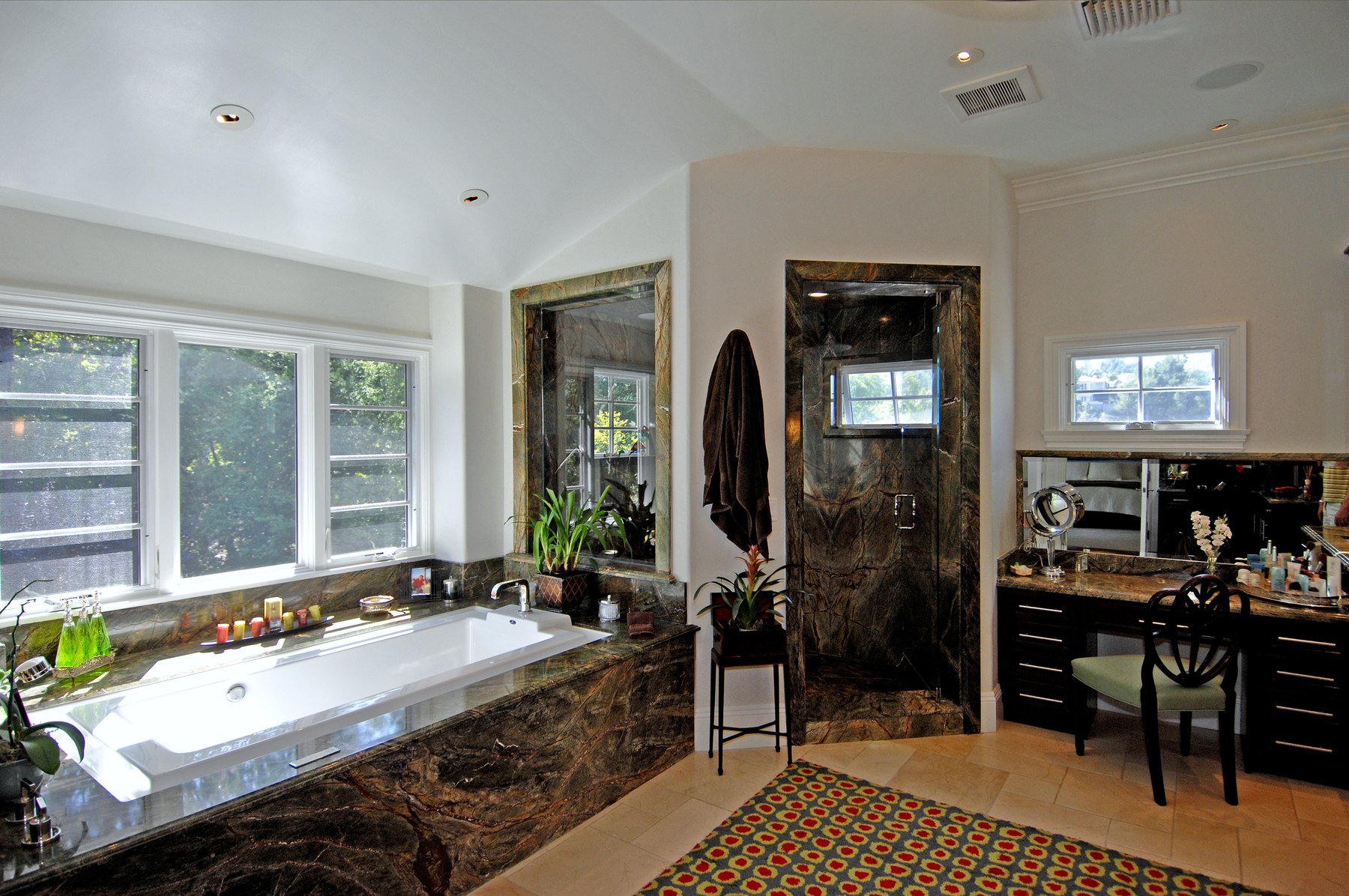 Principal bath with a marble tub surround and a dressing table